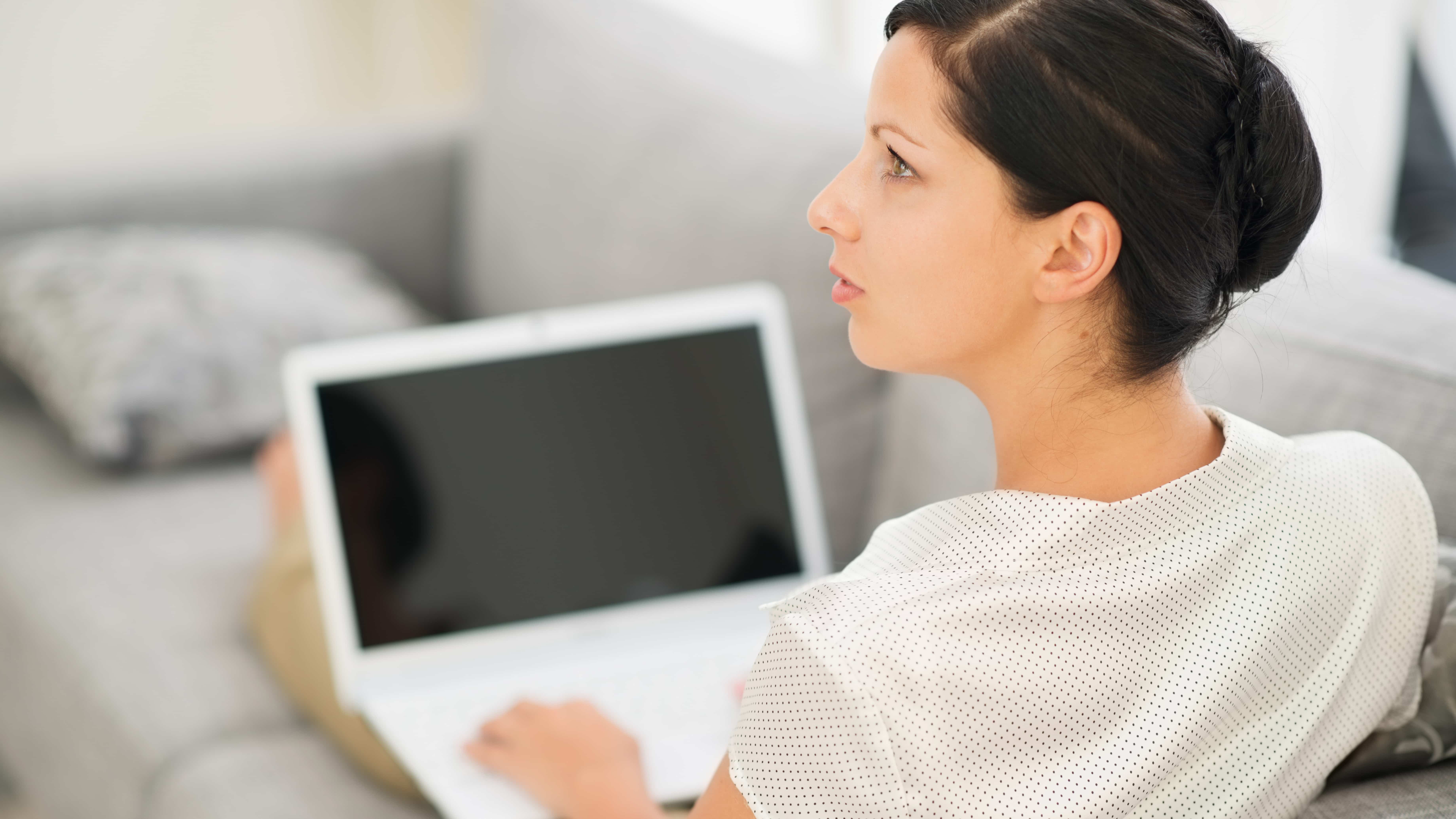 A women thinking while on the computer