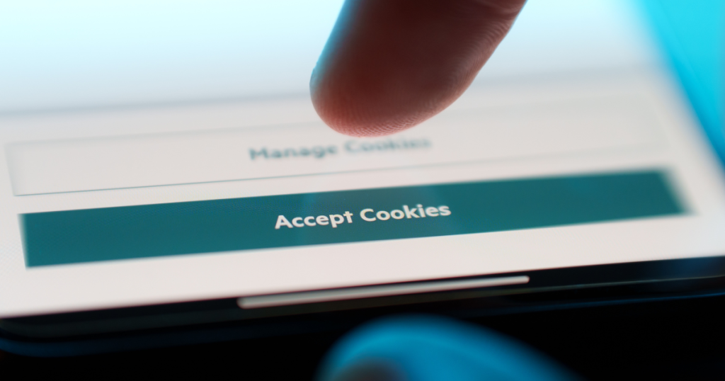 Finger hovering over "accept cookies" button on phone screen