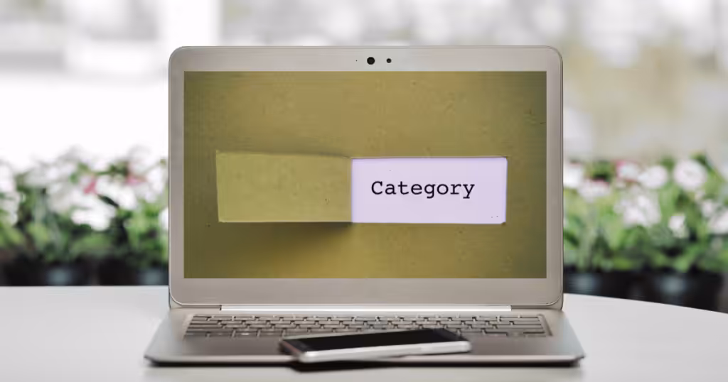 Laptop with green screen and the word "category"