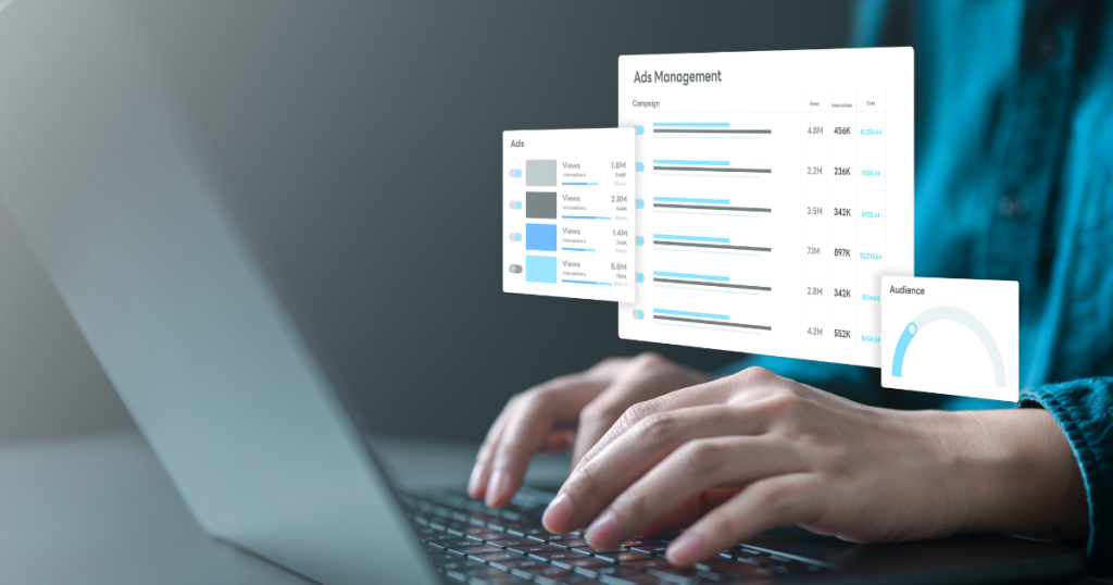 Hands typing on a laptop with digital advertising dashboards and analytics overlays on screen